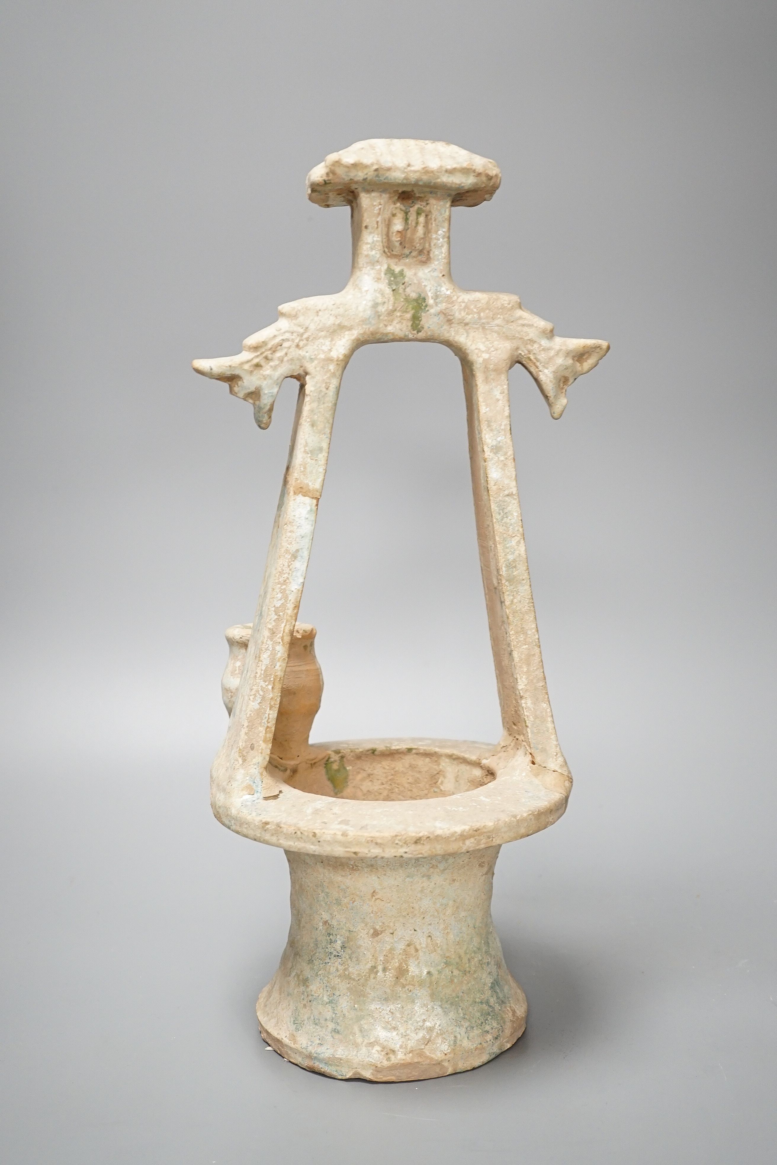 A Chinese Han dynasty green glazed model of a well, mineral iridescence to glaze, height 37cm